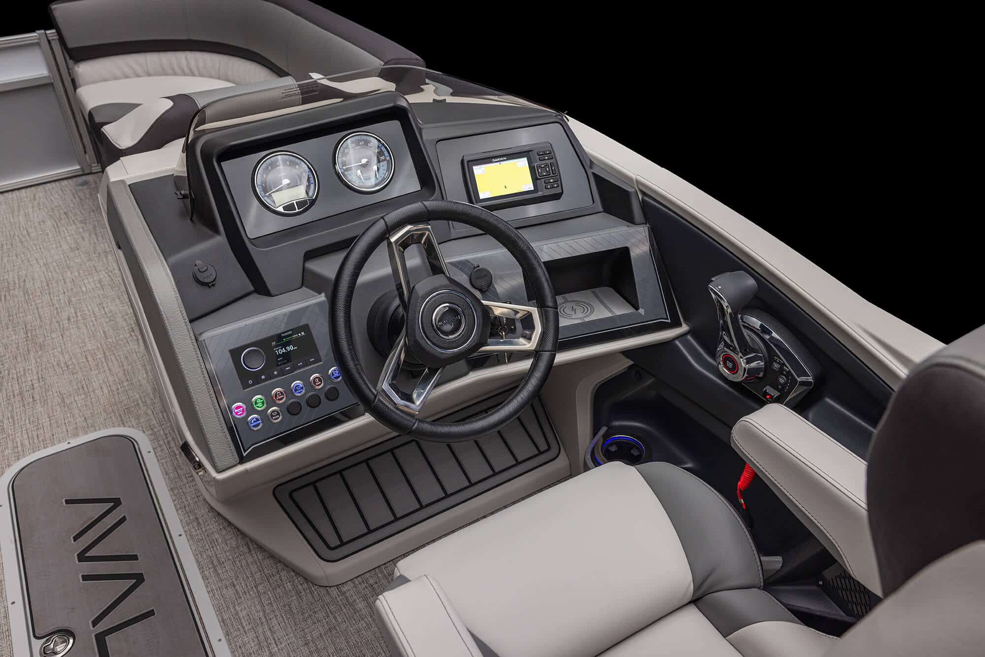 A close-up view of a modern boat's control console featuring a steering wheel, various gauges, a touchscreen display, and numerous buttons and switches. The surrounding area includes a cushioned seat and textured flooring. The background is black. Product Name: Catalina Rear Fish