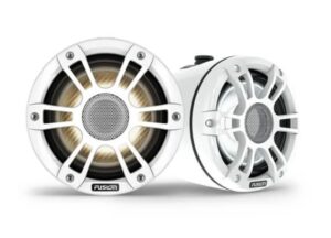 Two white round Fusion brand marine speakers are shown. The speakers feature a protective grille cover with a mesh center. One speaker is positioned facing forward, while the other is slightly angled to the side, showcasing both the front and side views.