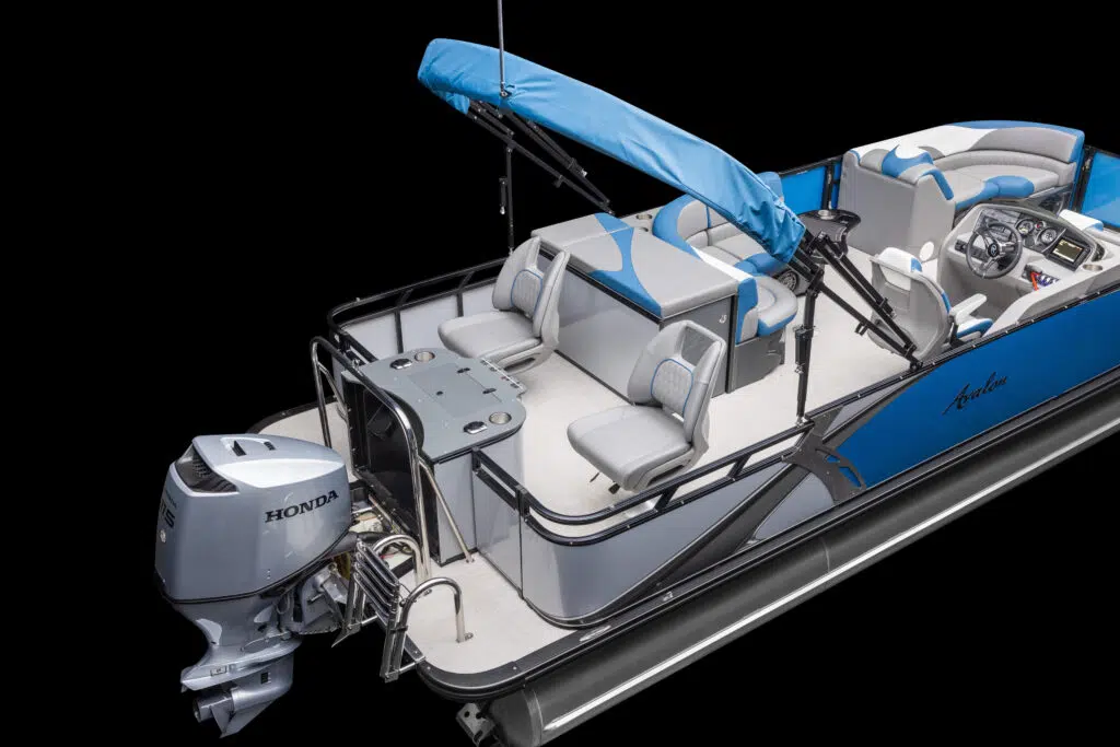 A blue and gray pontoon boat with a Honda outboard motor. The interior features cushioned seating, a control console, and a blue canopy. Two foldable chairs and a table with cup holders are at the back, providing space for relaxation and socializing.