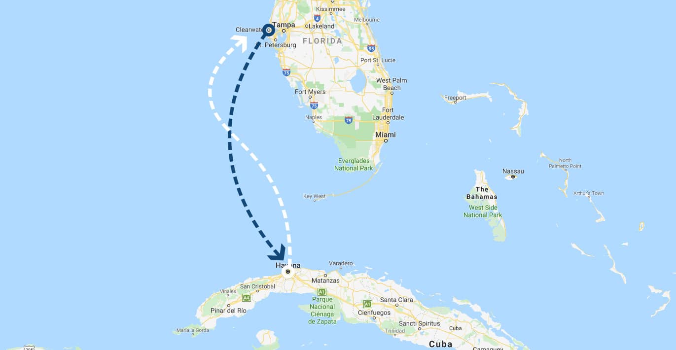 A map showing a flight path from Clearwater, Florida, USA, to Havana, Cuba. The dashed flight path line starts from Clearwater, goes through the Gulf of Mexico, and ends in Havana. Nearby cities such as Tampa, Miami, and Nassau are also visible on the map.