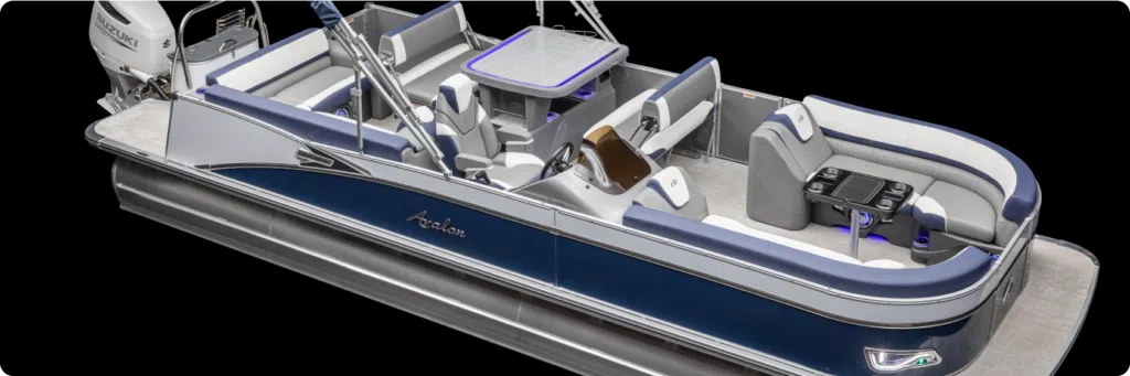 A sleek, modern pontoon boat with aluminum pontoons features plush seating with white and blue accents, a table, and a steering console. It is equipped with cushioned seats, cup holders, and storage compartments, designed for leisure and comfort on the water.