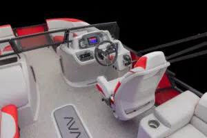 Interior view of a modern boat cockpit with a sleek, gray-and-red steering console. The dashboard has a digital display and multiple controls. The seating is upholstered in matching gray and red tones, and the floor has a light-colored texture.